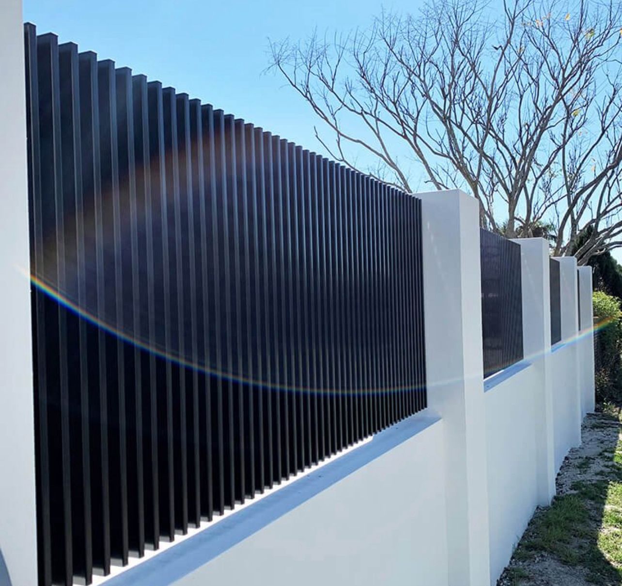 Premium black vertical slat fence with rendered base, Point Cook